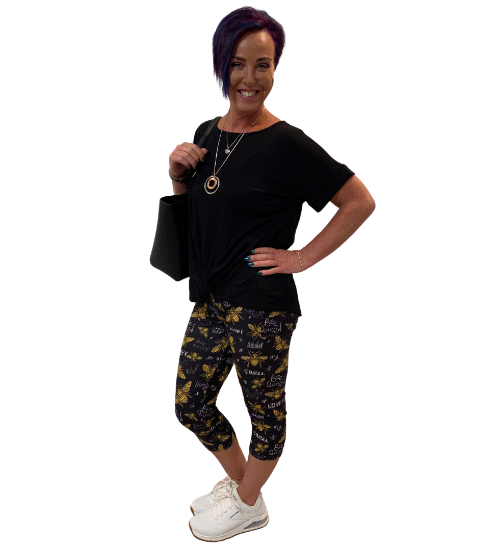 WOMAN WEARING BLACK SHIRT WITH BEE LEGGINGS